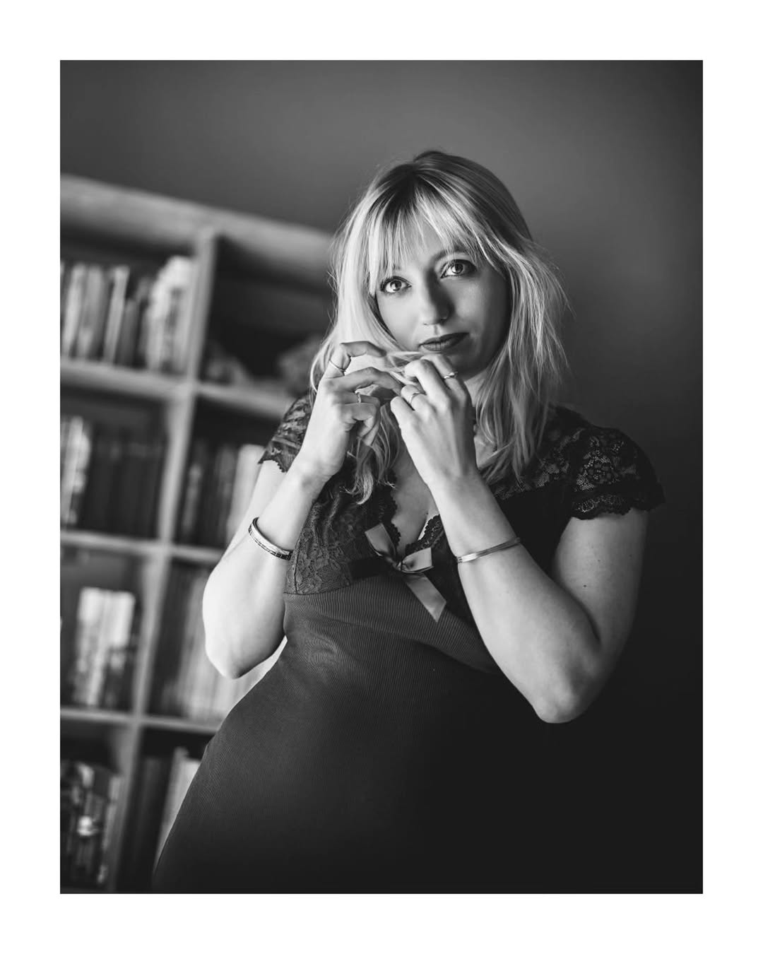 Black-and-white portrait of Nanie in front of a bookcase
