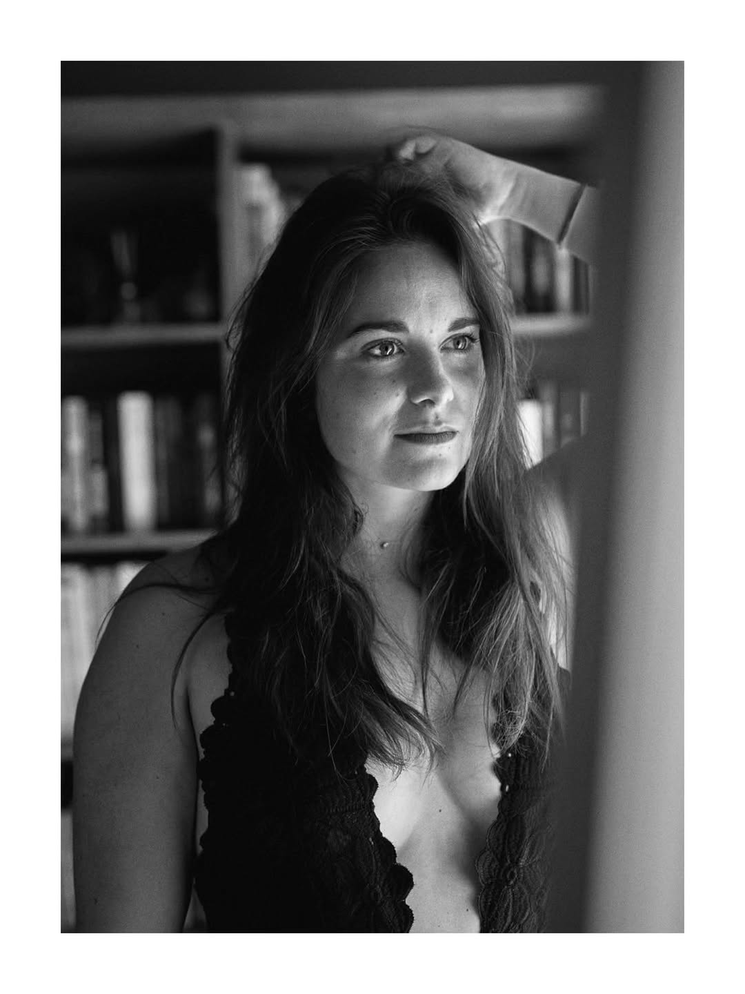 Black-and-white portrait of Éclat de Brune by a window