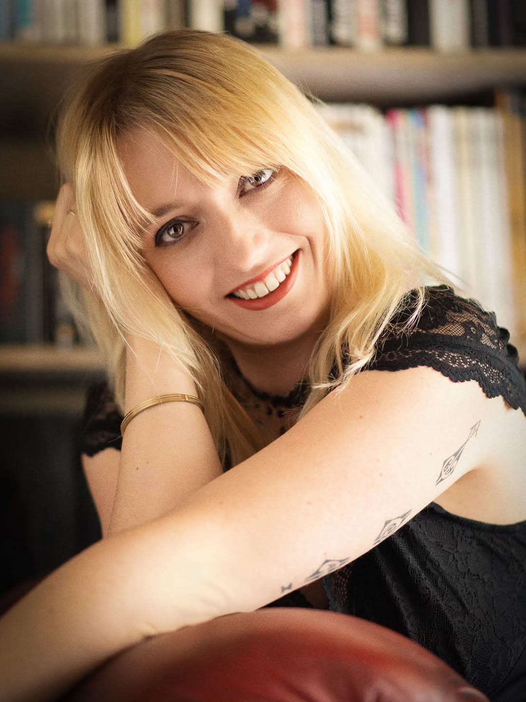 Smiling portrait of Nanie in front of a bookcase